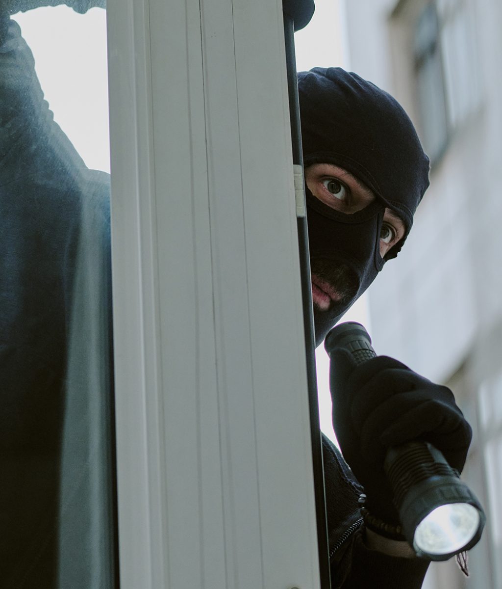 burglar breaking in through window.j